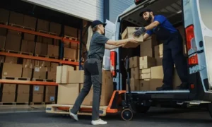 Professional legal courier service drivers loading legal document boxes into a delivery van